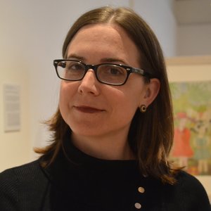 Headshot of Alison Amick. Alison has short brown hair and black glasses.