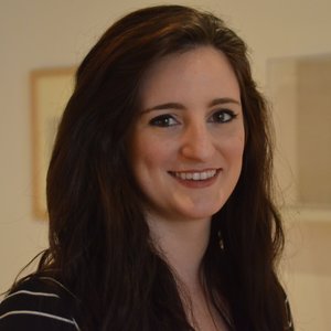 Headshot of Christina Stavros. Christina has long brown hair.